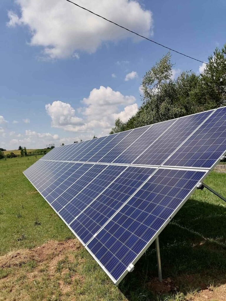 Saulės elektrinė ant žemės po giedru dangumi